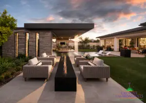 Custom backyard design with metal shade structure, outdoor dining area and artificial turf.