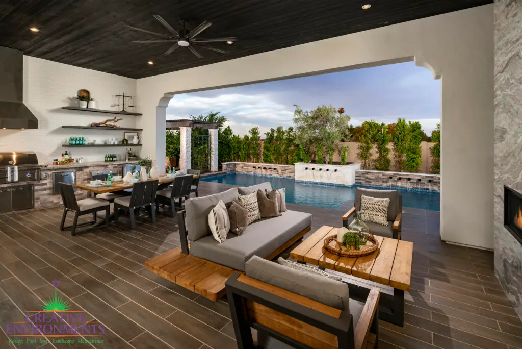 Custom backyard design with outdoor shelves and outdoor kitchen complete with hood, outdoor BBQ and outdoor fan.