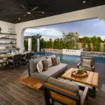 Custom backyard design with outdoor shelves and outdoor kitchen complete with hood, outdoor BBQ and outdoor fan.
