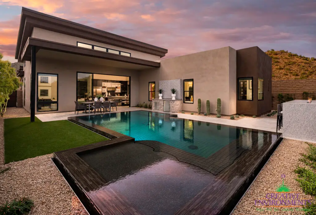 Custom backyard design with deco-tile pool, desert contemporary design and artificial turf.