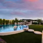 Custom backyard design with natural stone circular steps, circular pool and artificial turf.