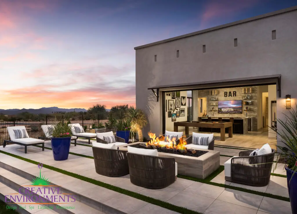 Custom backyard with seamless indoor/outdoor design, multiple seating areas and fire table.