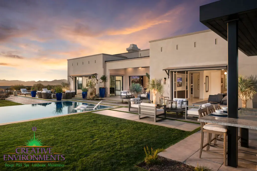 Custom backyard design with real grass, multiple seating areas and zero-edge pool.