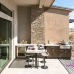 Backyard design with outdoor kitchen, wine fridge and outdoor dining area.