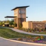 Custom community entrance with cantilevered planters, entry sign and metal trellis.