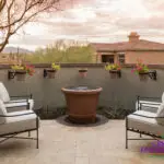 Custom backyard design with water feature, floating planters and outdoor seating area.