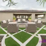Custom backyard design with artificial turf pattern, fire pit and outdoor shade structure.
