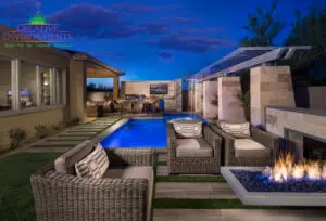 Custom backyard design with rain curtain water feature, cantilevered fire table and multiple seating areas.