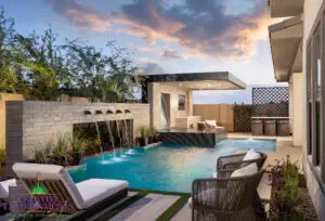 Custom backyard design with cantilevered shade structure and metal scupper water feature into unique-shaped pool.