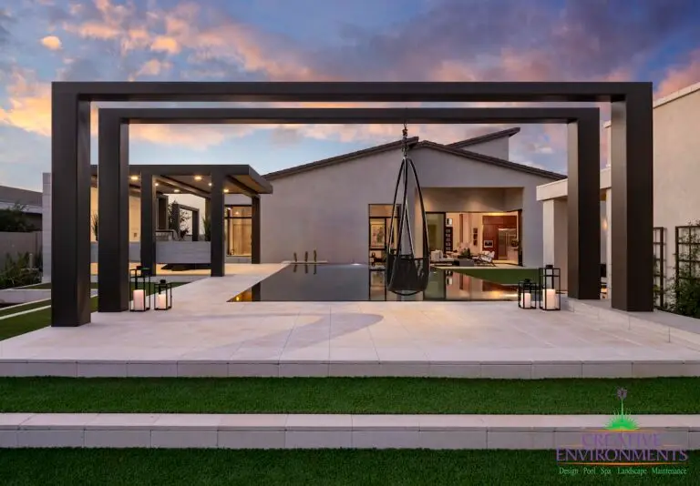 Custom metal structure with hanging swing, and patterned steps with natural stone and artificial turf.