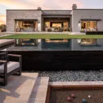 Custom backyard design with bocce ball court, pool and artificial turf
