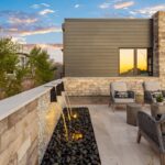 Custom front yard design with metal scupper water feature, seating area and succulents.