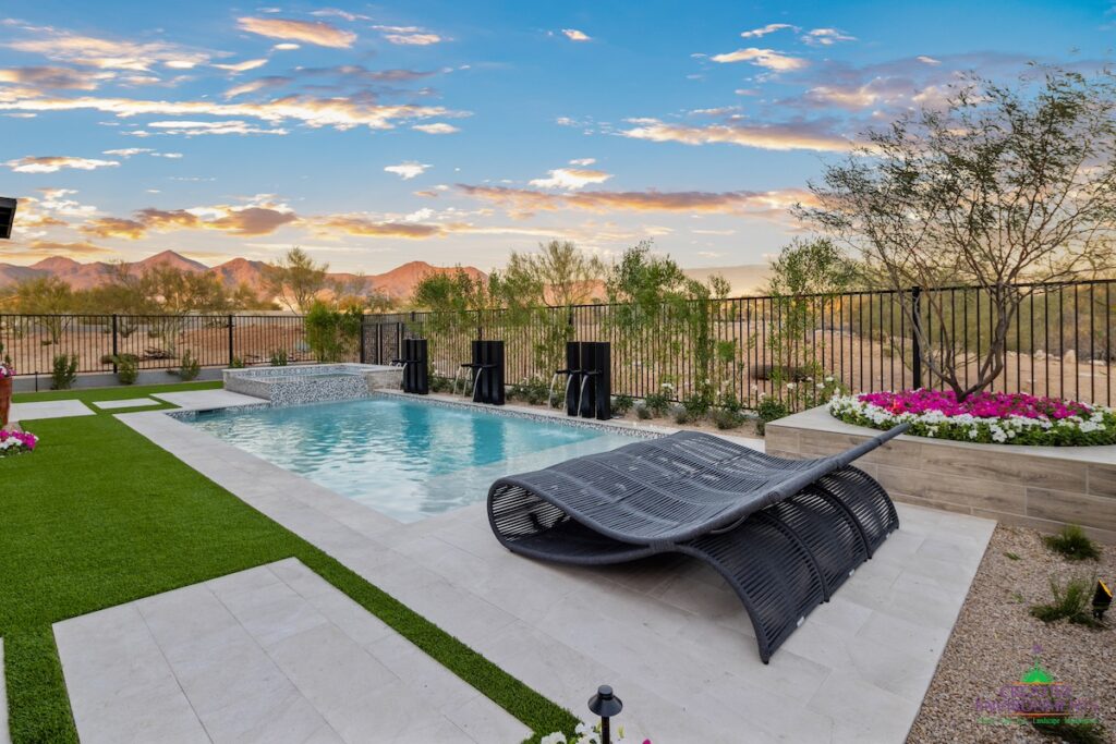 Custom backyard design with raised flower beds, multiple water features and raised spa.