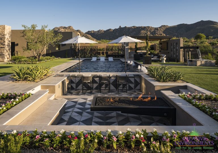 Custom backyard design with deco-tile sunken entertainment area, black pool and annuals.