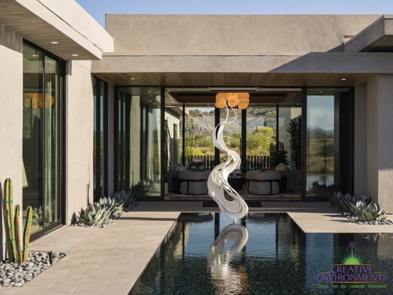 Custom backyard design with metal statement piece, zero-edge pool and succulents.