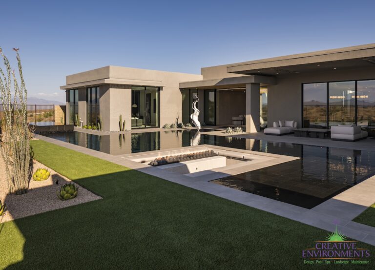 Custom backyard design with artificial turf, metal statement piece and sunken fire pit.