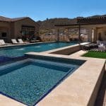 Custom backyard design with raised blue spa, baja shelf and resort-style pool.