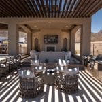 Custom backyard design with two-story shade structure, multiple seating areas and outdoor kitchen.