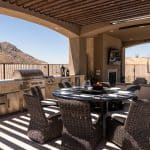 Custom backyard design with unique shade structure, multiple seating areas and outdoor kitchen.