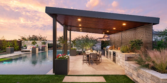 Custom backyard landscape with huge covered patio near a large custom pool