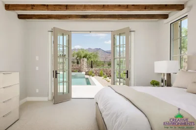 Custom indoor/outdoor fusion with natural stone accents, pool and organized planting.