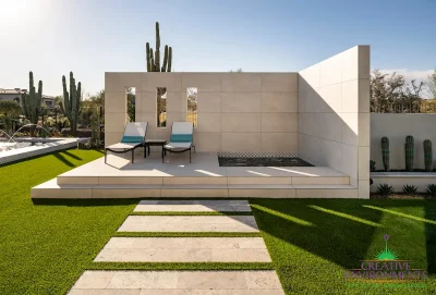 Custom backyard design with hot tub, privacy wall and natural stone steps.