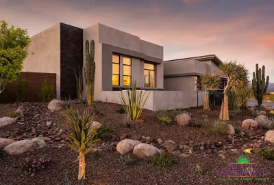 Custom front yard design with desert plants and up lighting.