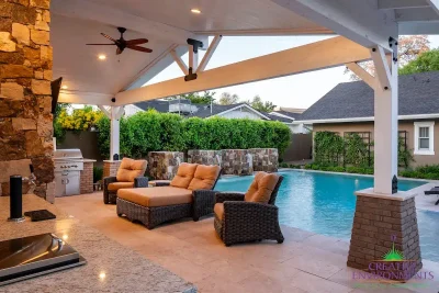 Custom farmhouse shade structure with outdoor fan, multiple seating areas and beer tap.