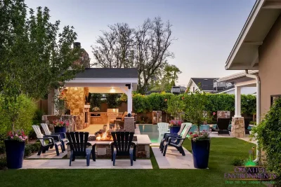 Custom backyard design with large, natural stone steps, farmhouse shade structure and large planters.