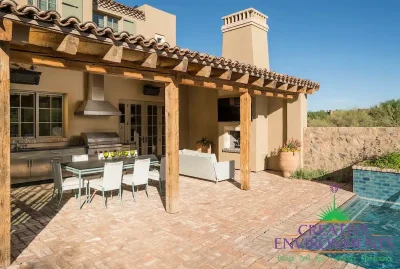 Custom backyard design with outdoor kitchen -- complete with hood, outdoor bbq, storage and outdoor TV.