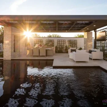 Custom backyard design with custom metal shade structure, metal trellis and black pool.