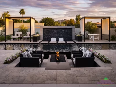 Custom backyard design with water wall into pool, Jesus steps and cabanas.