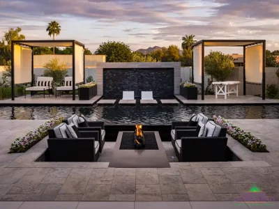 Custom backyard design with water wall into pool, Jesus steps and cabanas.