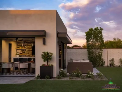 Custom backyard design with organized planting, large metal planters and artificial turf.