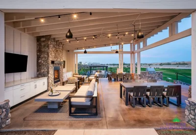 Custom community amenities with angled shade structure, multiple seating areas and floor-to-ceiling fireplace.