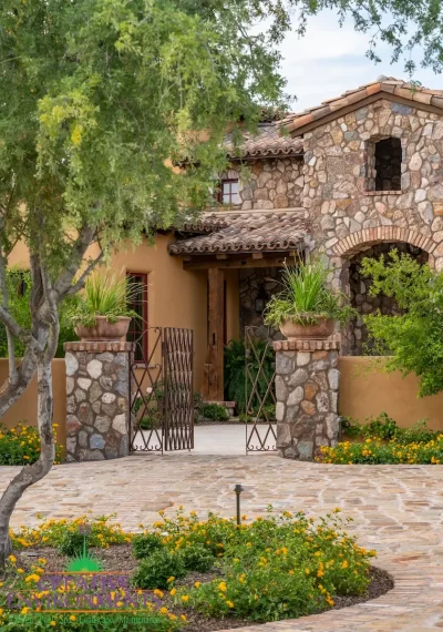 Front yard design with unique entryway and metal gate.