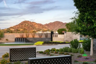 Custom community entrance with metal scupper water features, organized planting and luxury design.