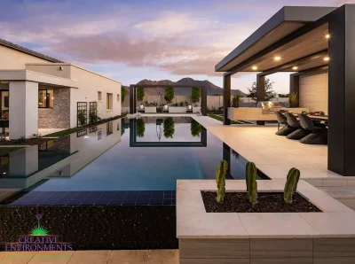 Custom metal shade structure with outdoor BBQ, multiple seating areas and black zero edge pool.