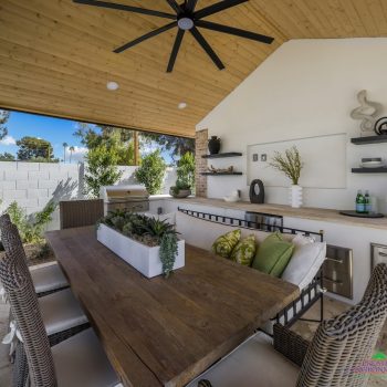 Custom backyard design with outdoor shade structure, built-in BBQ and recessed lighting.