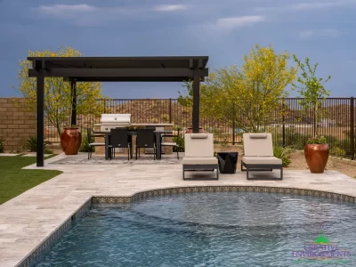 Custom backyard design with deco-tile pool, metal fencing and shade structure.