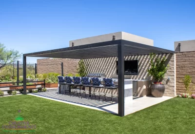 Custom backyard design with slatted metal shade structure, large planters and outdoor entertainment area.
