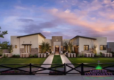 Custom front yard design with stone pillars, artificial turf and natural stone paver walkways.
