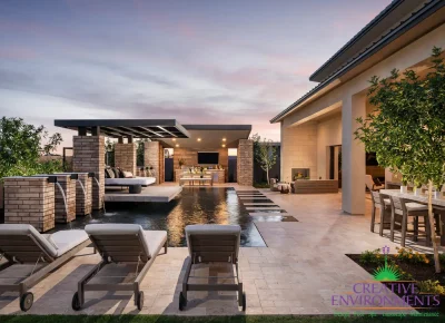 Custom backyard design with cantilevered shade structure, metal scupper water feature, zero-edge pool, Jesus steps and angled shade structure.