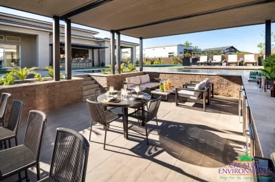 Backyard design with sunken entertainment area with multiple seating areas.