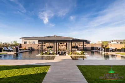 Backyard design with sunken outdoor kitchen and surrounding pool