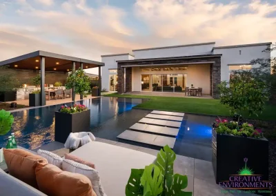 Backyard design with blue pool lights and Jesus steps.