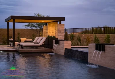 Custom backyard design with multiple seating areas, metal scupper water feature into pool and desert contemporary vibes.