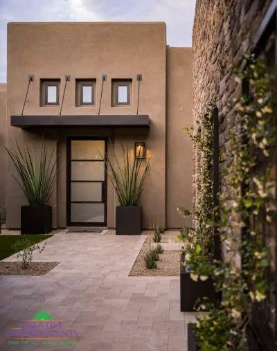 Custom front yard design with large metal planters, metal trellis and natural stone pathway.