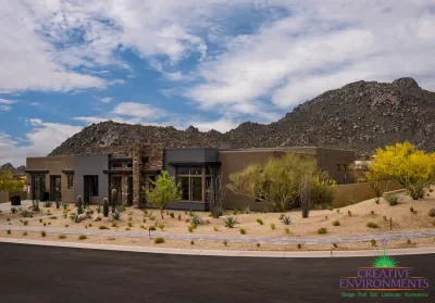 Custom front yard design with desert landscape design and paver walkway.