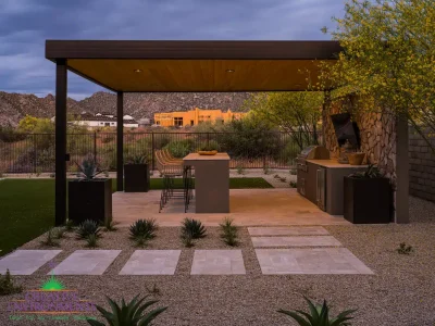 Custom backyard design with paver steps, metal shade structure and outdoor bar seating.